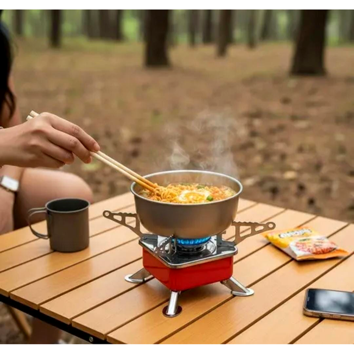 Cooking noodles in a pot on the ZORACook mini gas stove on a camping table