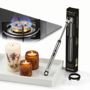 ZORACook Arc BBQ Lighter with its box, a rechargeable electric lighter beside a gas stove and candles