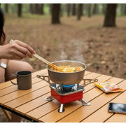 ZORACook Portable Mini Gas Stove being used to cook on a camping table